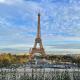 A picture of the Eiffel Tower from afar with a blue sky background