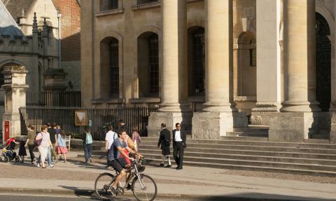 Photograph of a bicycle passing the Clarendon Building