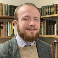 Timothy Powell in front of bookshelves